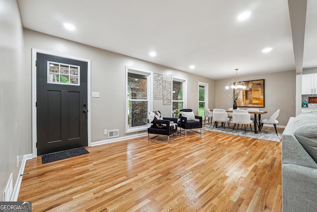 2771 Smithsonia Way, Tucker, GA 30084 - living room with light wood-style floors, baseboards, recessed lighting, and a chandelier