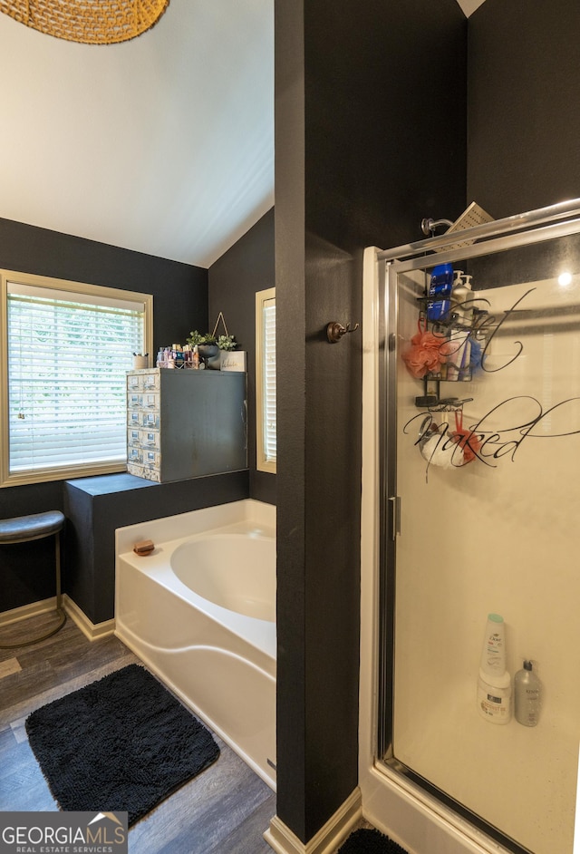 6813 Grand Hickory Dr, Braselton, GA 30517 - full bathroom with wood finished floors, a stall shower, a garden tub, and lofted ceiling