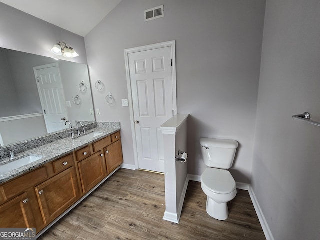 4677 Liberty Square Dr, Acworth, GA 30101 - full bath featuring wood finished floors, vaulted ceiling, and double vanity