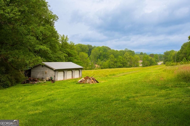 357 Camp Wahsega Rd, Dahlonega, GA 30533 - view of yard with a garage, a view of trees, and an outdoor structure