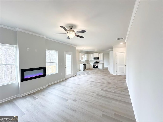 5032 Falcon Pt Lot 142, Douglasville, GA 30135 - unfurnished living room featuring ornamental molding, a glass covered fireplace, a ceiling fan, light wood-style floors, and baseboards