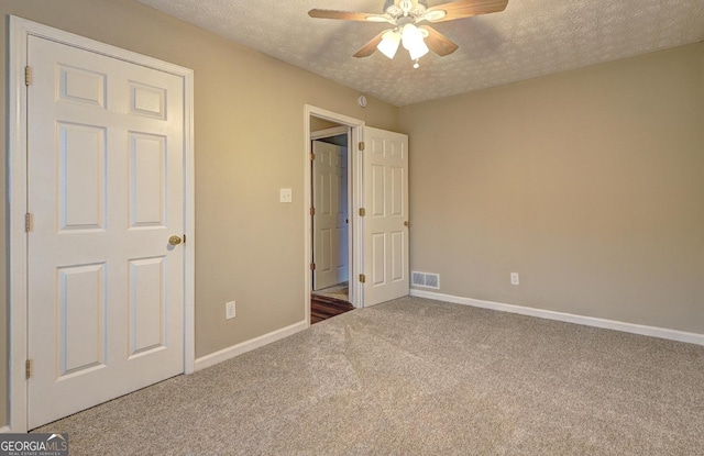 221 Ashley Oaks Dr, Mcdonough, GA 30253 - unfurnished bedroom featuring carpet flooring, a textured ceiling, baseboards, and ceiling fan