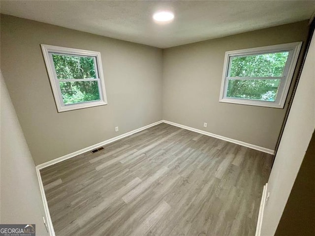 2489 Hillside Dr, Macon, GA 31206 - spare room featuring plenty of natural light, wood finished floors, and baseboards
