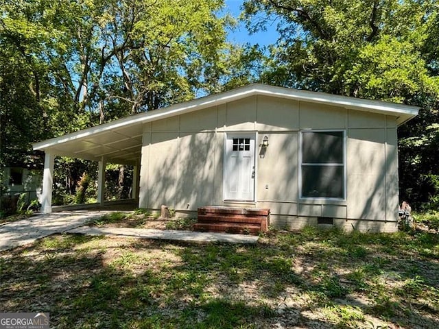 2489 Hillside Dr, Macon, GA 31206 - view of front facade with crawl space, entry steps, concrete driveway, and a carport
