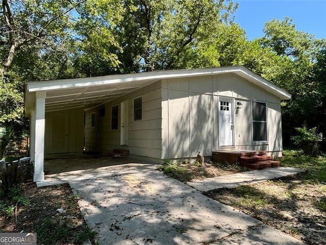2489 Hillside Dr, Macon, GA 31206 - view of front of house with concrete driveway, an attached carport, and entry steps