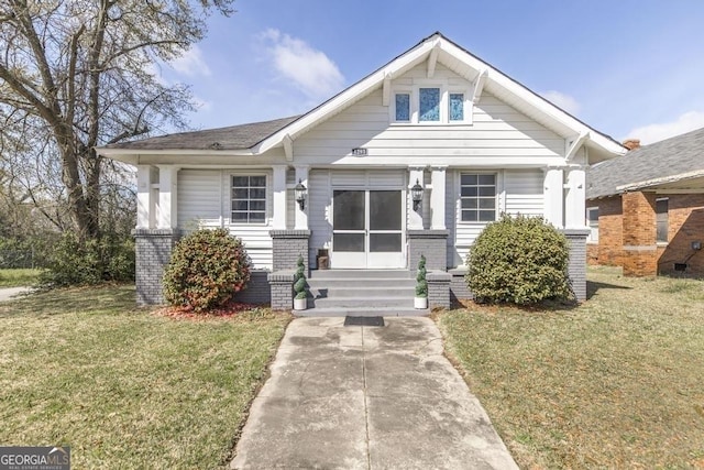 1293 Courtland Ave, Macon, GA 31204 - bungalow-style home with a front lawn and brick siding