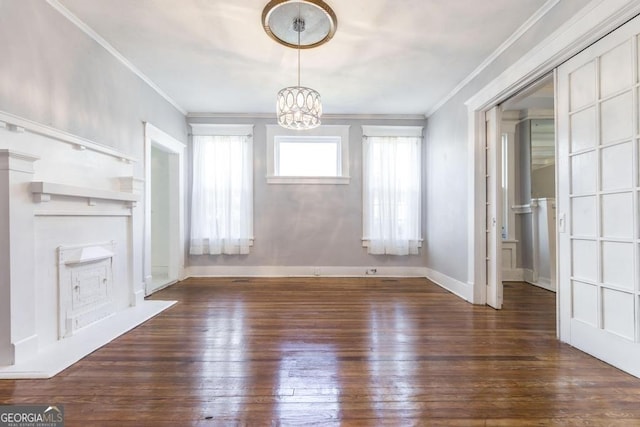1293 Courtland Ave, Macon, GA 31204 - unfurnished living room featuring hardwood / wood-style floors, crown molding, a chandelier, and baseboards