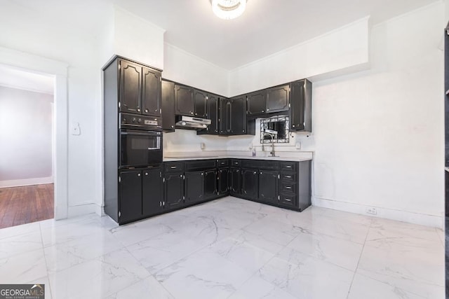 1293 Courtland Ave, Macon, GA 31204 - kitchen featuring black appliances, under cabinet range hood, baseboards, light countertops, and light marble finish floors