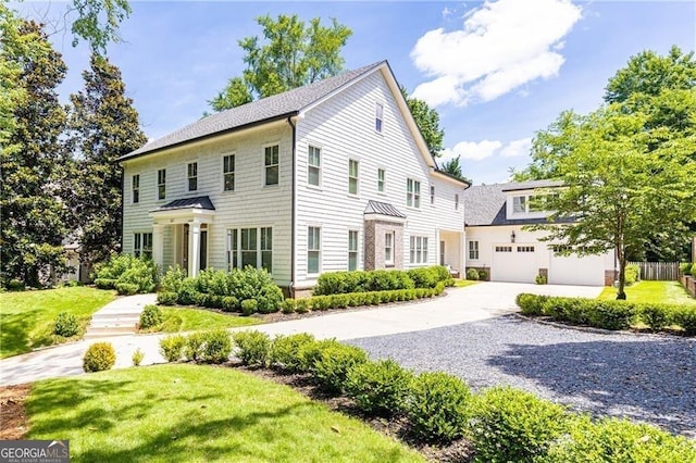 4015 Wieuca Rd NE, Atlanta, GA 30342 - colonial inspired home with driveway, a front yard, and a standing seam roof