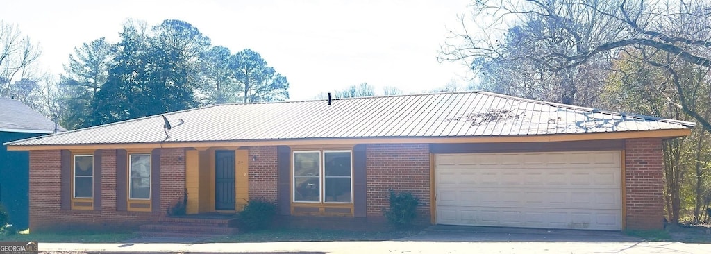 210 Brown St, Lagrange, GA 30241 - ranch-style home with brick siding, an attached garage, driveway, and metal roof