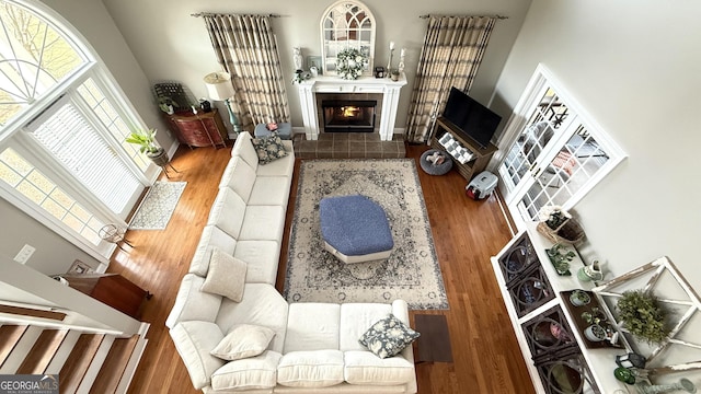 297 Old Clarkesville Mill Rd, Clarkesville, GA 30523 - living area featuring wood finished floors, a fireplace, baseboards, and a towering ceiling