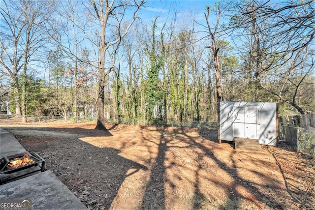 1040 Forest E Dr, Stone Mountain, GA 30088 - view of yard with a wooded view and a fire pit