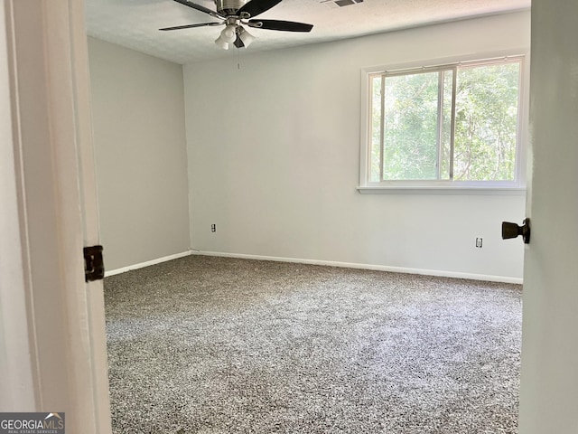 1040 Forest E Dr, Stone Mountain, GA 30088 - unfurnished room with carpet flooring, ceiling fan, baseboards, and a textured ceiling