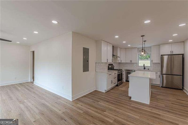 525 Rosemont Dr, Decatur, GA 30032 - kitchen with stainless steel appliances, wall chimney exhaust hood, light wood-style flooring, light countertops, and recessed lighting