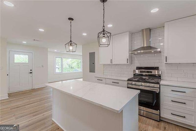 525 Rosemont Dr, Decatur, GA 30032 - kitchen featuring wall chimney range hood, stainless steel range with gas stovetop, backsplash, white cabinets, and recessed lighting