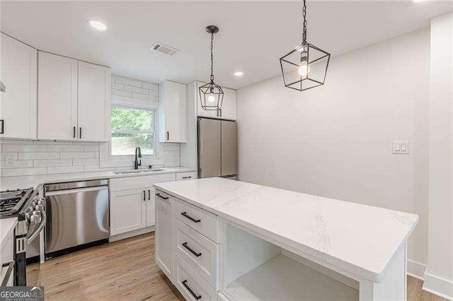 525 Rosemont Dr, Decatur, GA 30032 - kitchen with stainless steel appliances, a sink, light countertops, white cabinetry, and recessed lighting