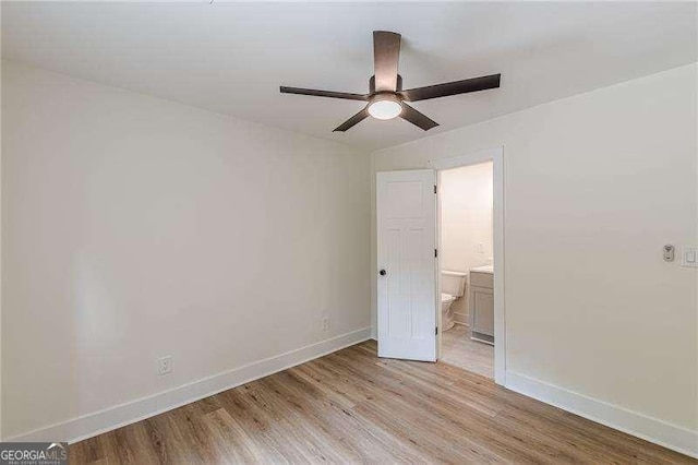 525 Rosemont Dr, Decatur, GA 30032 - unfurnished bedroom with light wood finished floors, baseboards, connected bathroom, and ceiling fan