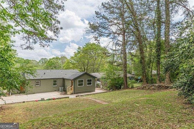 525 Rosemont Dr, Decatur, GA 30032 - rear view of house with a lawn and a patio