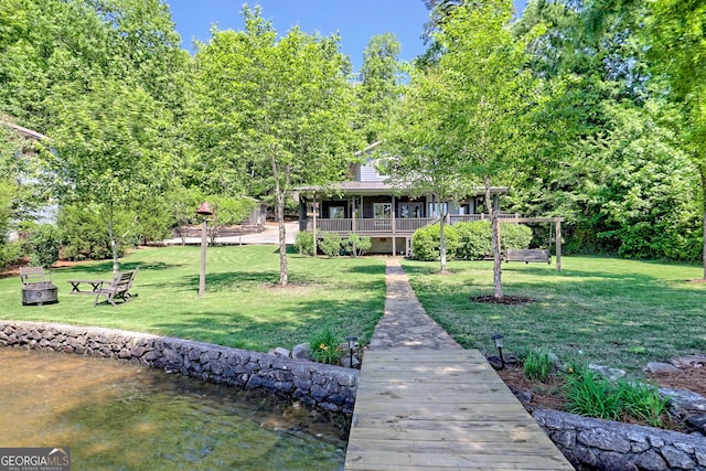 4610 Murray Cove Rd, Tiger, GA 30576 - back of house featuring a yard, a porch, and a fire pit