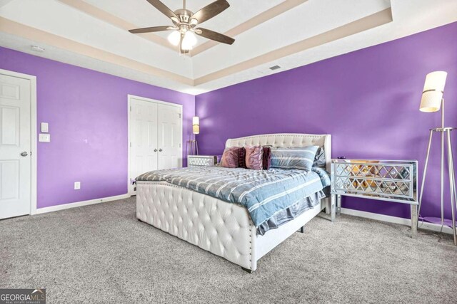 11072 Pebble Ridge Dr, Hampton, GA 30228 - carpeted bedroom featuring a tray ceiling, ensuite bathroom, and ceiling fan