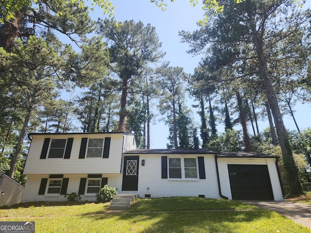 2615 Old S Ct, Jonesboro, GA 30236 - tri-level home featuring a garage, brick siding, a front yard, and concrete driveway
