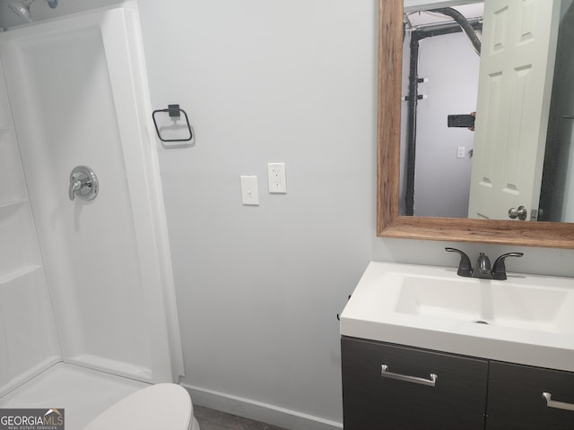 2615 Old S Ct, Jonesboro, GA 30236 - bathroom with vanity, a shower, baseboards, and toilet