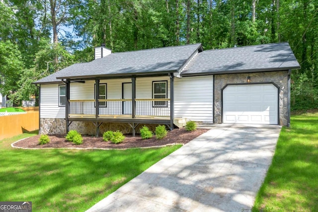 4043 Chedworth Way, Stone Mountain, GA 30083 - view of front of house with covered porch, an attached garage, stone siding, a chimney, and a front yard