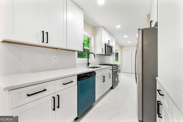 4043 Chedworth Way, Stone Mountain, GA 30083 - kitchen with stainless steel appliances, a sink, light marble finish floors, white cabinetry, and backsplash