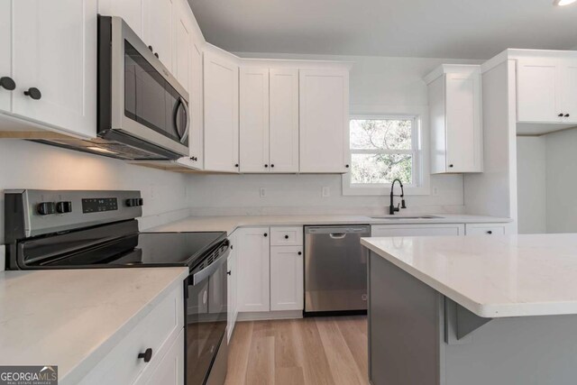3110 Granada Way, Gainesville, GA 30506 - kitchen with stainless steel appliances, light wood-style flooring, and white cabinets