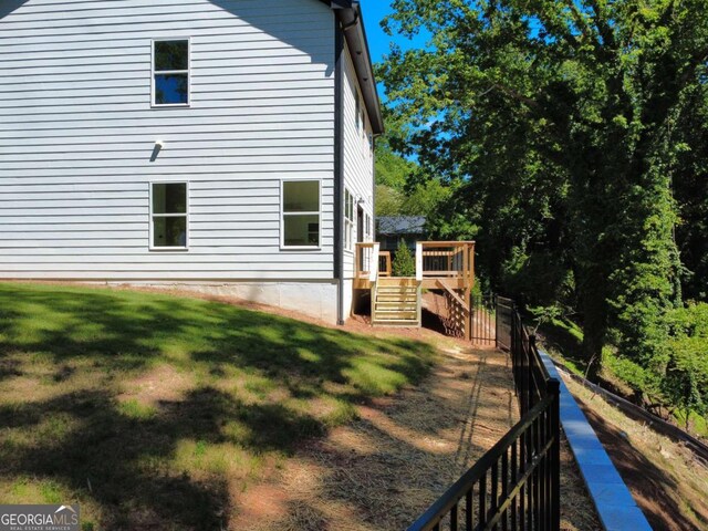 3110 Granada Way, Gainesville, GA 30506 - view of home's exterior with stairway, a wooden deck, and a lawn