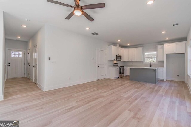 3110 Granada Way, Gainesville, GA 30506 - unfurnished living room with healthy amount of natural light, a ceiling fan, light wood-type flooring, and recessed lighting