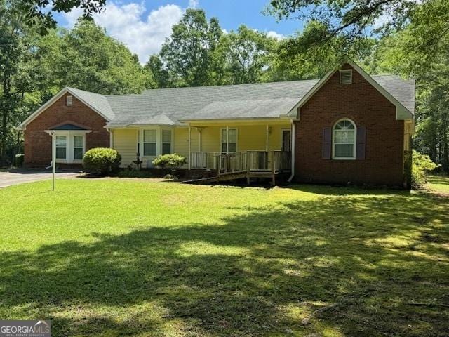 140 Shoal Creek Rd, Griffin, GA 30223 - ranch-style house featuring covered porch, a front lawn, and brick siding