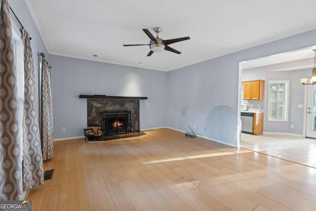 1645 Four Notch Rd, Carrollton, GA 30116 - unfurnished living room with ceiling fan, a lit fireplace, a chandelier, and light wood-style floors