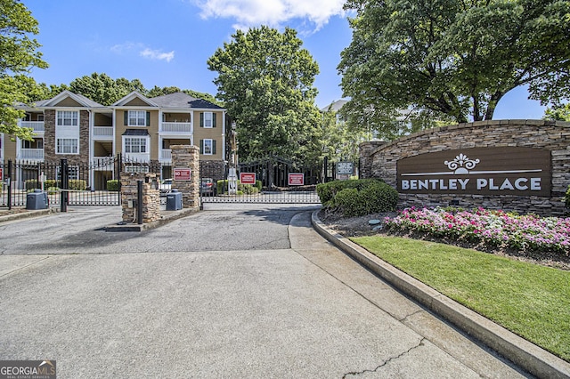 328 Bentley Pl Unit 328, Tucker, GA 30084 - view of asphalt road featuring curbs, a gated entry, and a gate