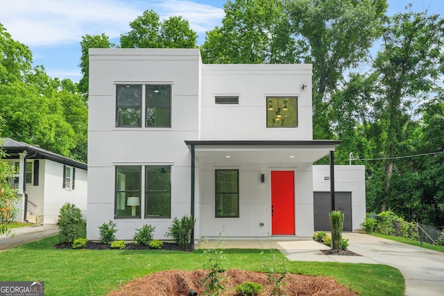 2926 5th St SW, Atlanta, GA 30315 - contemporary house featuring concrete driveway, stucco siding, and a front lawn