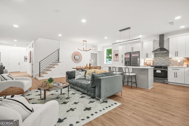 2926 5th St SW, Atlanta, GA 30315 - living area featuring stairs, recessed lighting, light wood-style floors, a chandelier, and baseboards