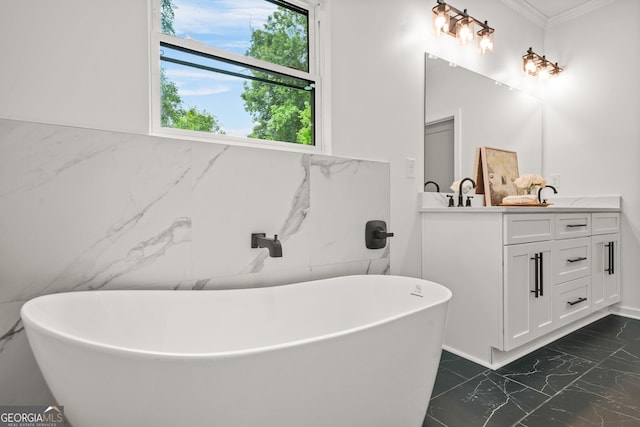 2926 5th St SW, Atlanta, GA 30315 - full bath featuring marble look tiles, double vanity, ornamental molding, a freestanding tub, and tile walls