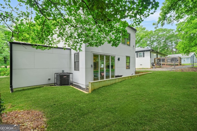 2926 5th St SW, Atlanta, GA 30315 - rear view of property with central AC, a yard, and stucco siding