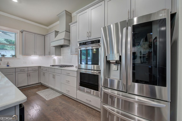 2657 Cedar Pine Way, Atlanta, GA 30360 - kitchen with stainless steel appliances, crown molding, light countertops, decorative backsplash, and dark wood-type flooring