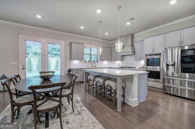 2657 Cedar Pine Way, Atlanta, GA 30360 - kitchen featuring appliances with stainless steel finishes, premium range hood, gray cabinets, a kitchen island, and backsplash