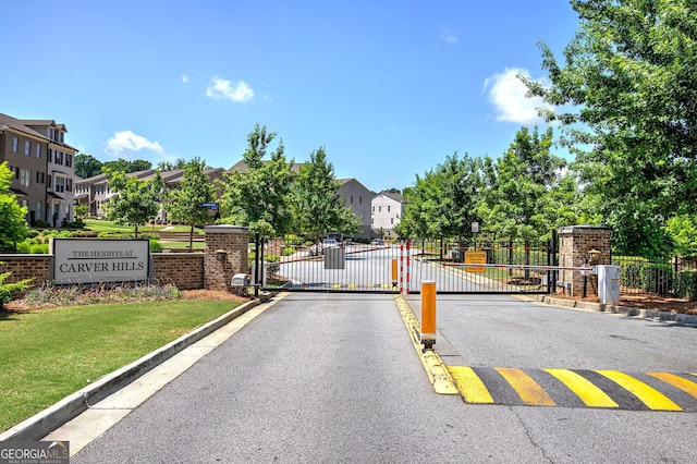 2657 Cedar Pine Way, Atlanta, GA 30360 - view of asphalt street featuring a gate, curbs, a gated entry, and a residential view