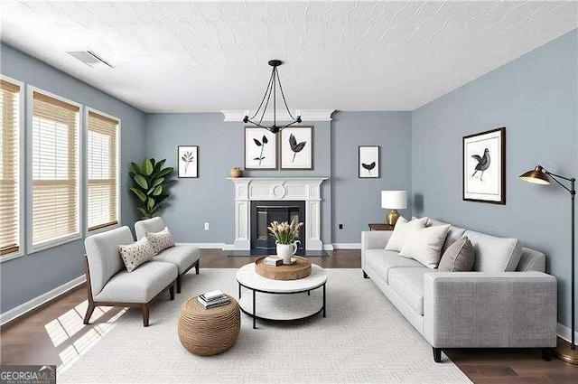 152 Maxton Ave, Dallas, GA 30132 - living area with wood finished floors, a chandelier, and a glass covered fireplace