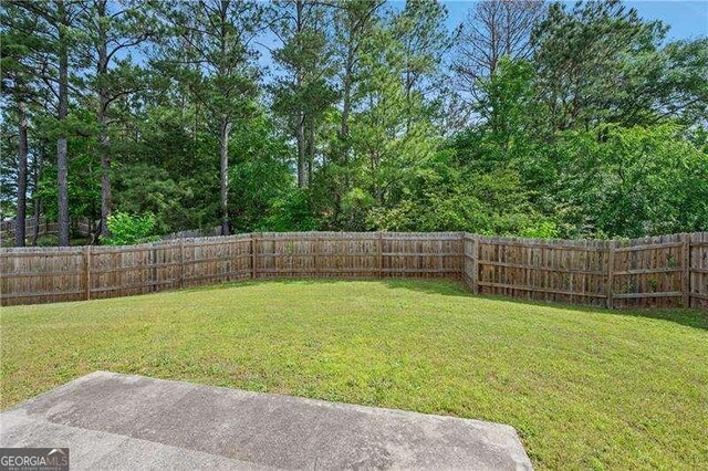 152 Maxton Ave, Dallas, GA 30132 - fenced backyard with a patio