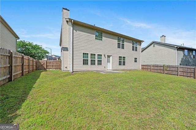 152 Maxton Ave, Dallas, GA 30132 - back of property with a fenced backyard and a chimney