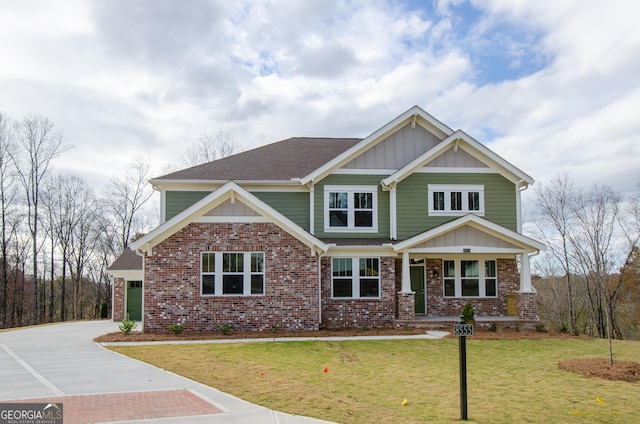 8555 Scenic Ridge Way, Ball Ground, GA 30107 - craftsman-style house with board and batten siding, concrete driveway, a front yard, and brick siding