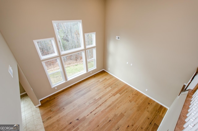 8555 Scenic Ridge Way, Ball Ground, GA 30107 - unfurnished room with light wood finished floors and baseboards