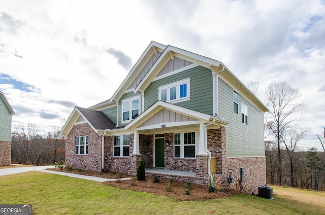 8555 Scenic Ridge Way, Ball Ground, GA 30107 - craftsman-style home with board and batten siding, covered porch, a front lawn, and brick siding