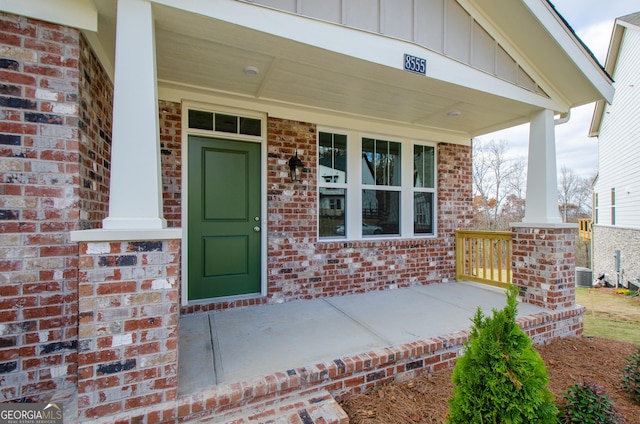 8555 Scenic Ridge Way, Ball Ground, GA 30107 - doorway to property with a porch, board and batten siding, and brick siding