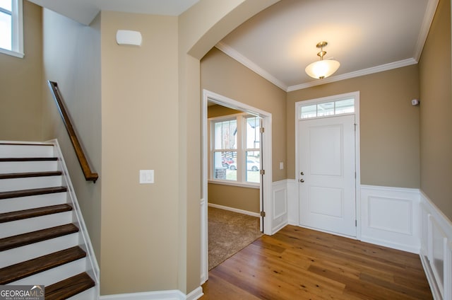 8555 Scenic Ridge Way, Ball Ground, GA 30107 - foyer featuring wood finished floors, a wainscoted wall, arched walkways, ornamental molding, and stairway