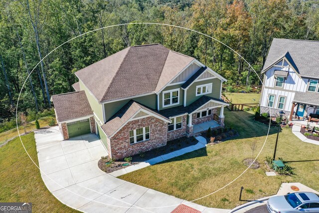 8555 Scenic Ridge Way, Ball Ground, GA 30107 - view of front of property featuring a wooded view, board and batten siding, driveway, a garage, and a front lawn